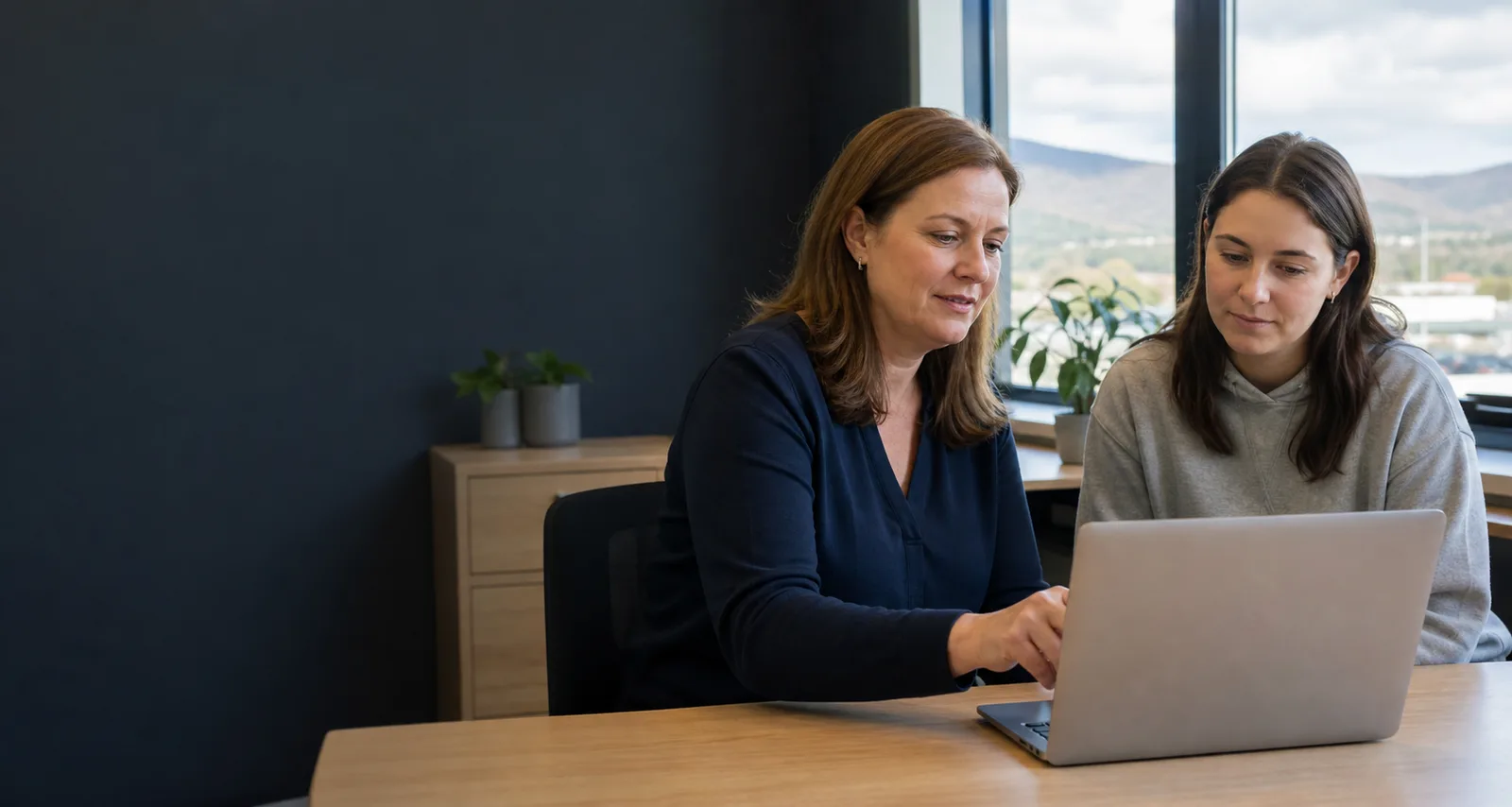An NSTA team member helping a student complete an online enrolment